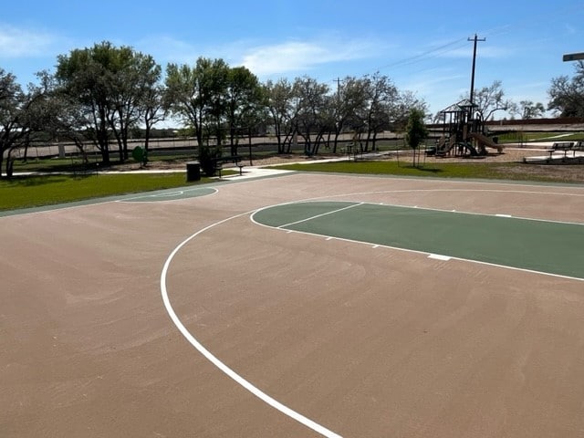 view of sport court featuring a playground