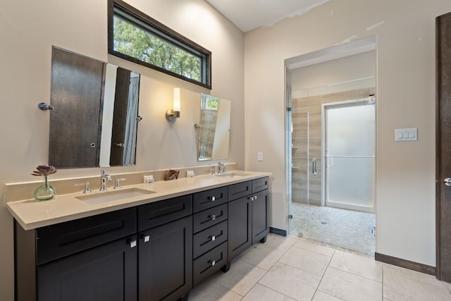 bathroom with tile patterned floors, vanity, and a shower with door