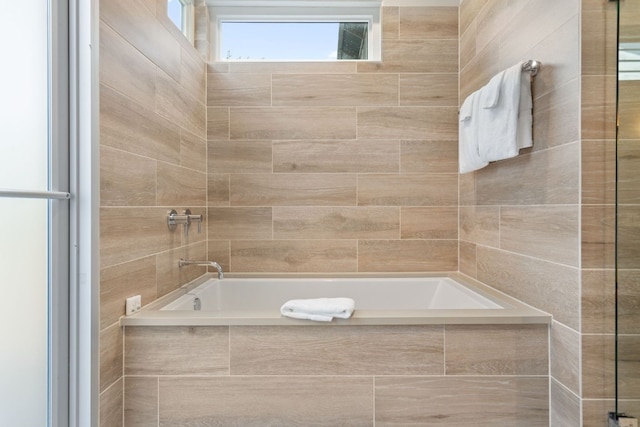 bathroom featuring tiled bath