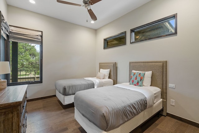 bedroom with dark hardwood / wood-style floors and ceiling fan