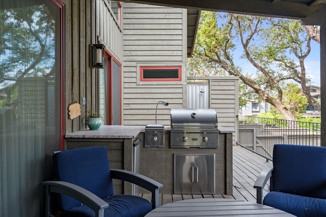 view of patio featuring a wooden deck, area for grilling, and a grill