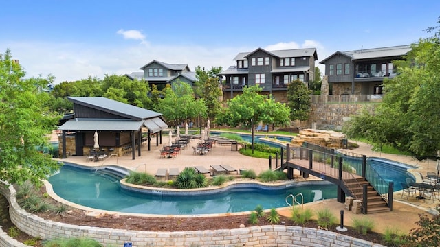 pool with a patio area and fence