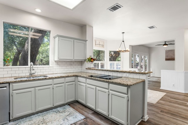 kitchen with dark wood-type flooring, ceiling fan with notable chandelier, and a healthy amount of sunlight