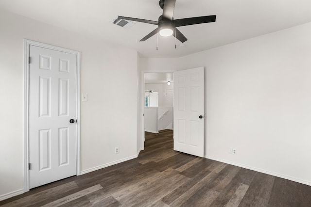 unfurnished bedroom with dark hardwood / wood-style flooring and ceiling fan