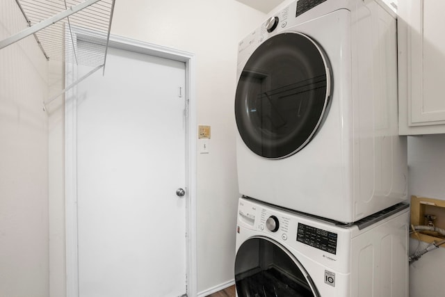 washroom featuring stacked washer / dryer and hardwood / wood-style floors