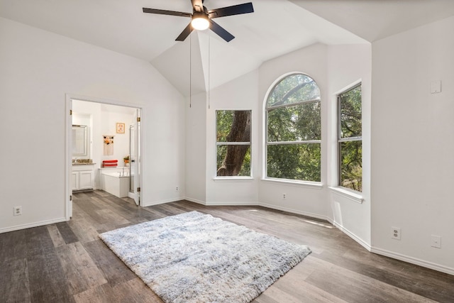 unfurnished bedroom with ensuite bathroom, wood-type flooring, ceiling fan, and vaulted ceiling