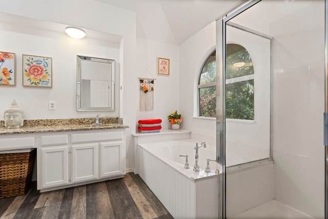 bathroom with separate shower and tub, wood-type flooring, and vanity