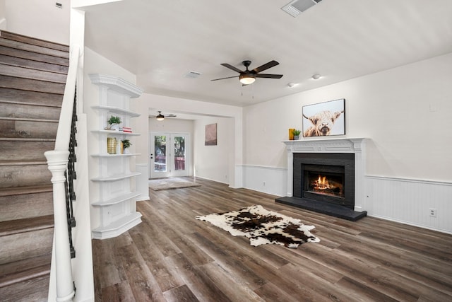 unfurnished living room featuring french doors, ceiling fan, and hardwood / wood-style floors