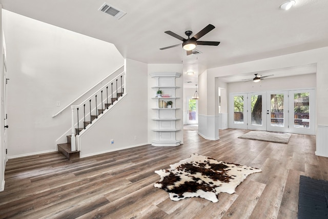 unfurnished living room with wood-type flooring, french doors, and ceiling fan