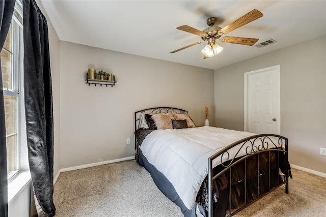 bedroom featuring ceiling fan and carpet