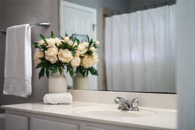 bathroom with walk in shower and vanity