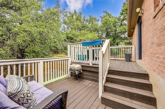 wooden deck featuring a grill and an outdoor hangout area