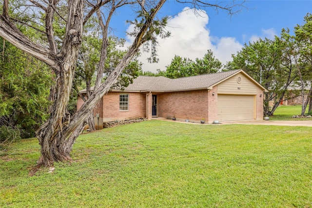 single story home featuring a garage and a front lawn