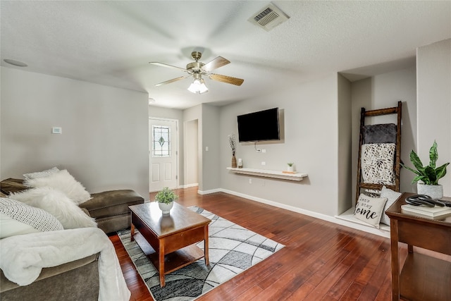 living room with ceiling fan and hardwood / wood-style floors