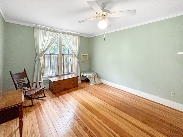 sitting room featuring ceiling fan, light hardwood / wood-style floors, and ornamental molding