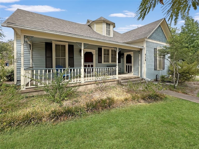 view of front of property featuring covered porch and a front lawn