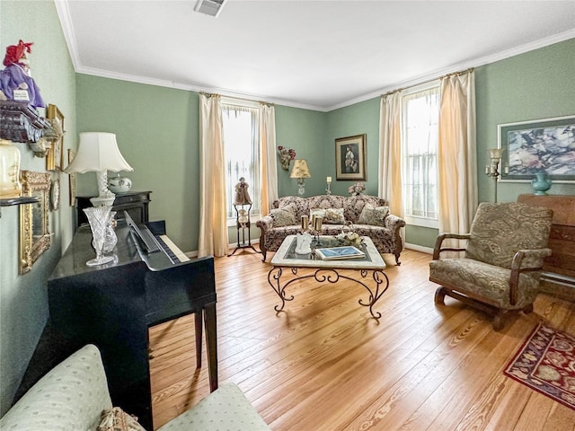 living room featuring ornamental molding and light hardwood / wood-style flooring