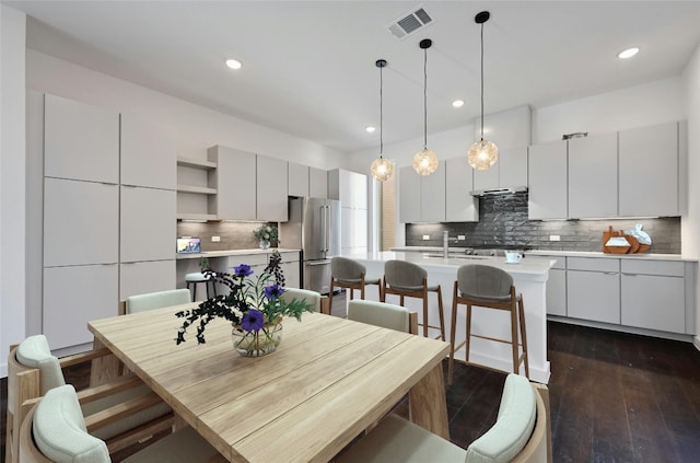 dining area featuring sink and dark hardwood / wood-style floors