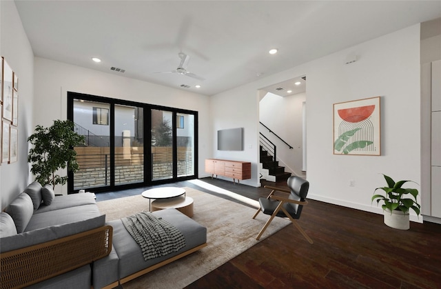 living room with hardwood / wood-style flooring and ceiling fan