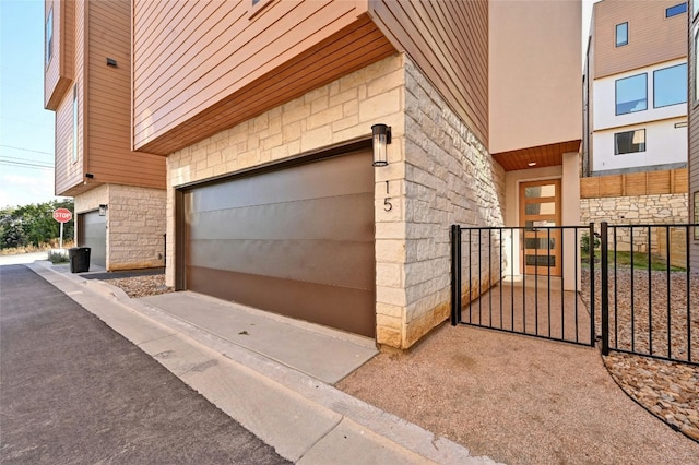garage featuring a gate and fence