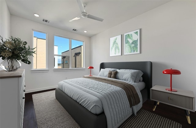 bedroom with dark hardwood / wood-style floors and ceiling fan