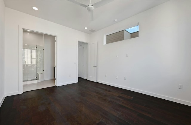 unfurnished bedroom featuring dark wood-type flooring, ceiling fan, and ensuite bathroom