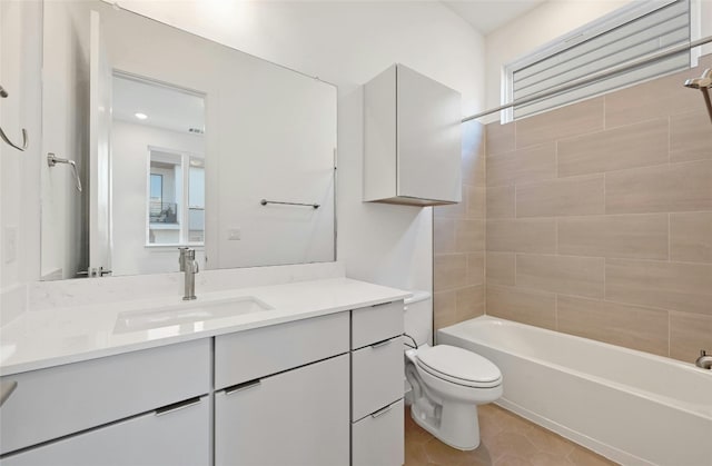 full bathroom featuring toilet, tiled shower / bath, vanity, and tile patterned floors