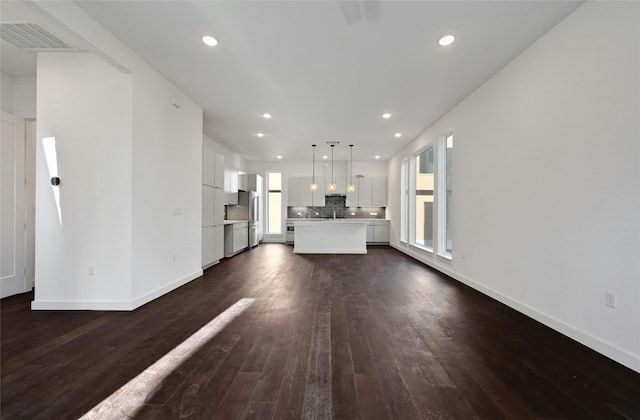 6821 Wolfcreek Pass Unit 15, Austin, TX 78749 - unfurnished living room with dark wood-type flooring, baseboards, and recessed lighting