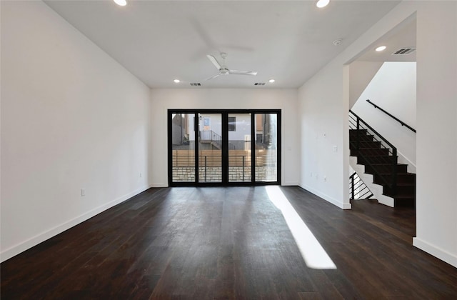 empty room with ceiling fan and dark hardwood / wood-style flooring