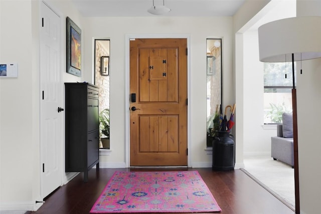 entryway featuring dark wood finished floors and baseboards