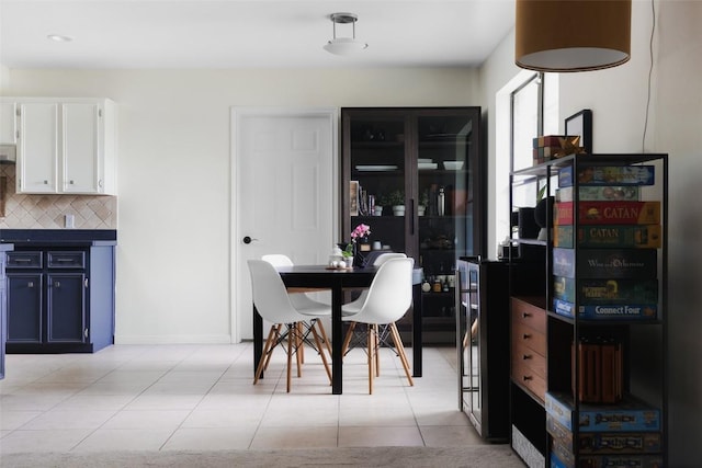 dining room featuring light tile patterned floors and baseboards