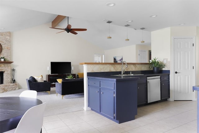 kitchen featuring a large fireplace, dishwasher, open floor plan, blue cabinetry, and a sink