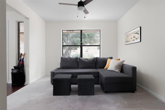 living room featuring carpet floors, ceiling fan, and baseboards