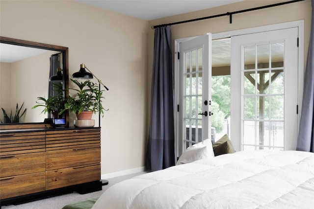 bedroom featuring access to outside and baseboards