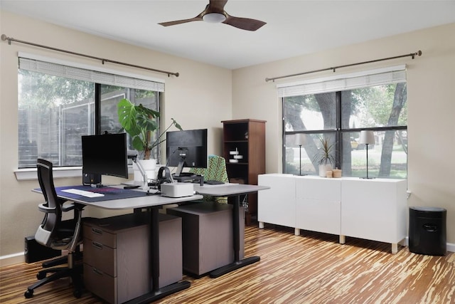 home office featuring ceiling fan, baseboards, and wood finished floors