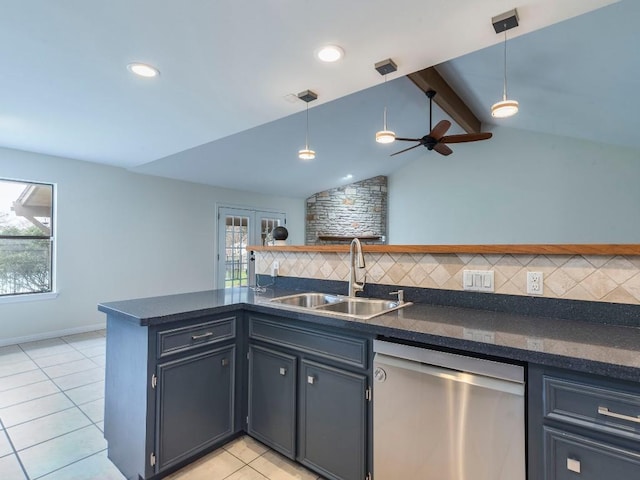 kitchen featuring light tile patterned floors, a sink, stainless steel dishwasher, decorative backsplash, and dark countertops