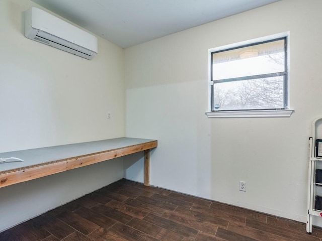 unfurnished office with a wall mounted AC and wood tiled floor