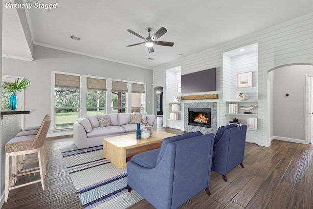 living room featuring ornamental molding, dark hardwood / wood-style flooring, and ceiling fan