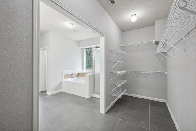 spacious closet with tile patterned floors