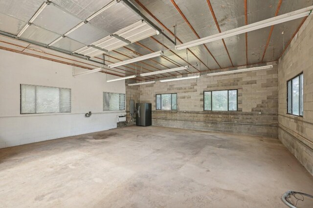 garage with stainless steel fridge