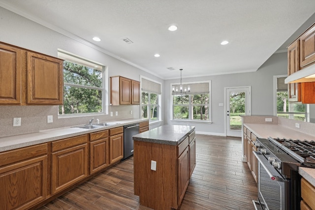 kitchen featuring dark hardwood / wood-style floors, a healthy amount of sunlight, a center island, and appliances with stainless steel finishes