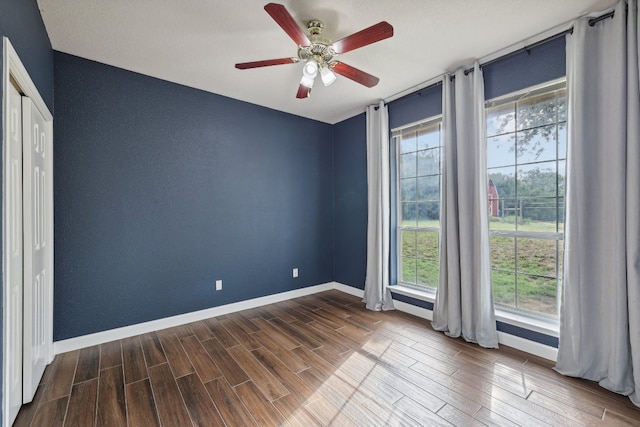 spare room featuring ceiling fan and hardwood / wood-style floors