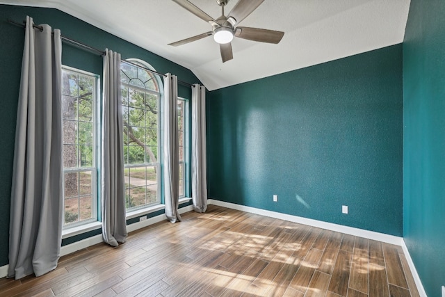 unfurnished room featuring ceiling fan, lofted ceiling, and hardwood / wood-style floors