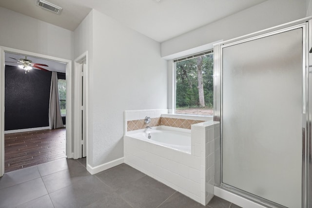 bathroom featuring plus walk in shower, ceiling fan, and wood-type flooring