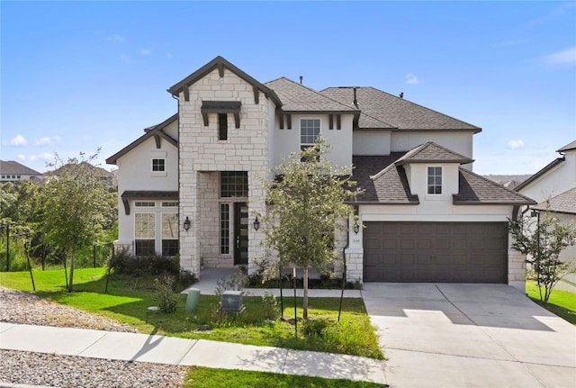 view of front of house with a garage and a front lawn