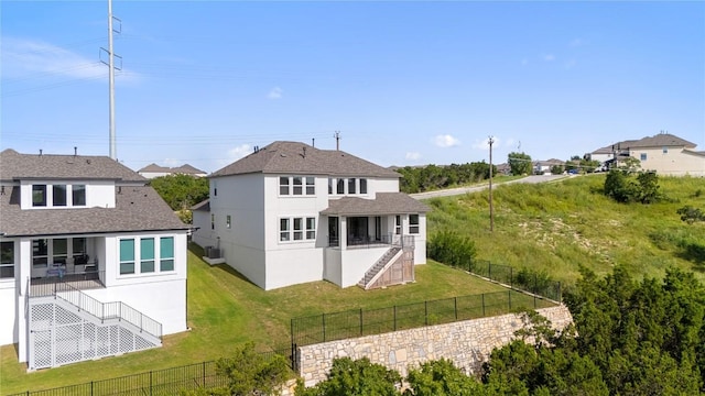 back of house featuring central AC unit and a lawn