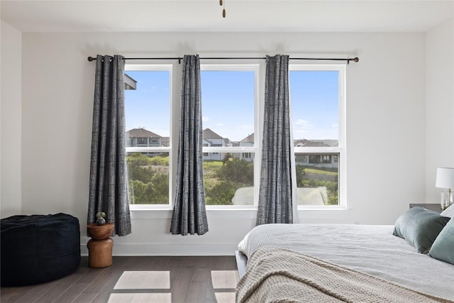 bedroom with dark wood-type flooring