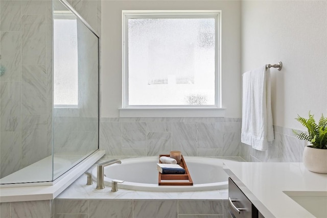 bathroom with independent shower and bath and vanity