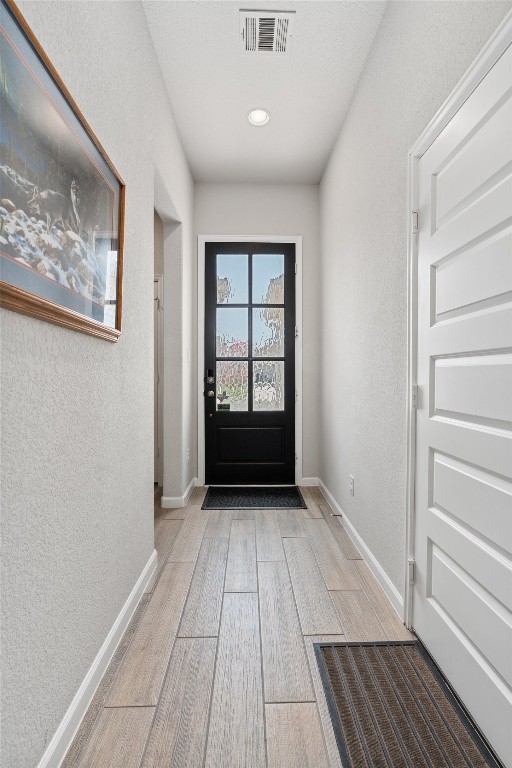 doorway with light hardwood / wood-style floors