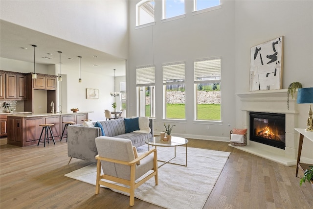 living room featuring a healthy amount of sunlight, hardwood / wood-style floors, and sink